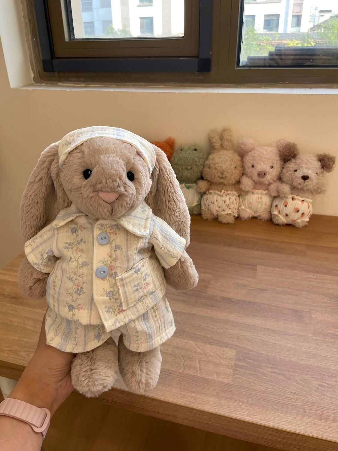 Bashful Bunny wearing cream floral pyjama set, held up