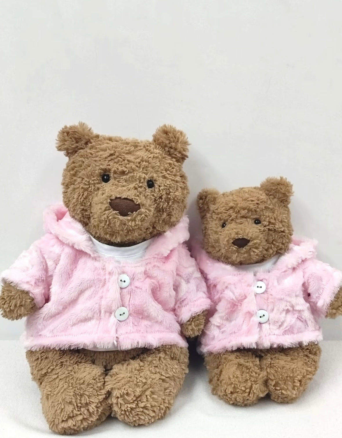 Bartholomew Bear large and small wearing matching pink hooded coats, front view