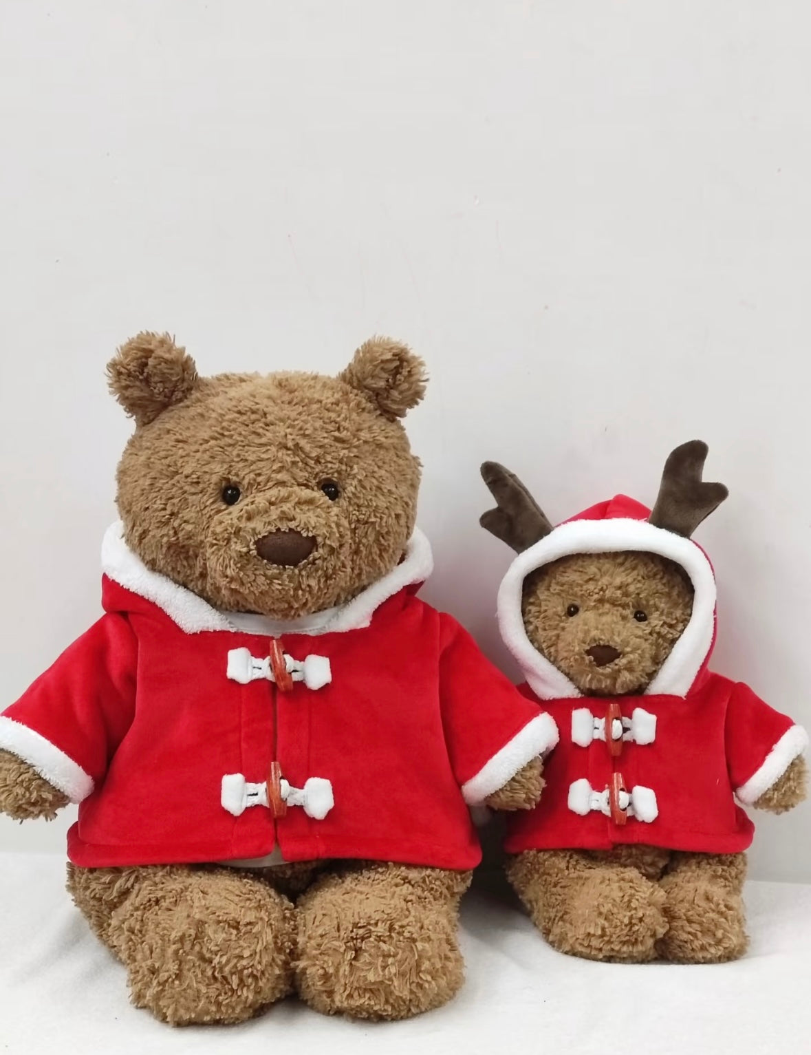 Bartholomew Bear large and small wearing red Santa duffle coats with white faux fur trim, front view