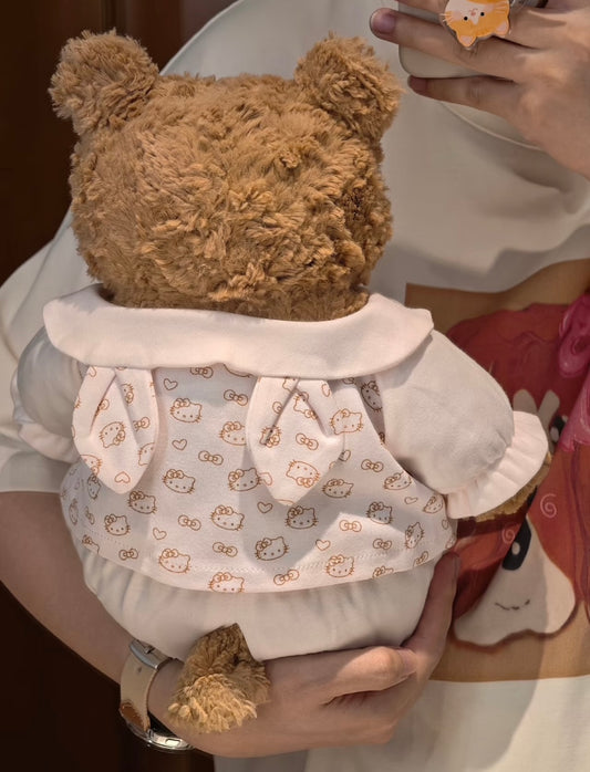 Back view of Bartholomew Bear in cream Hello Kitty romper showing bow tie detail on pinafore