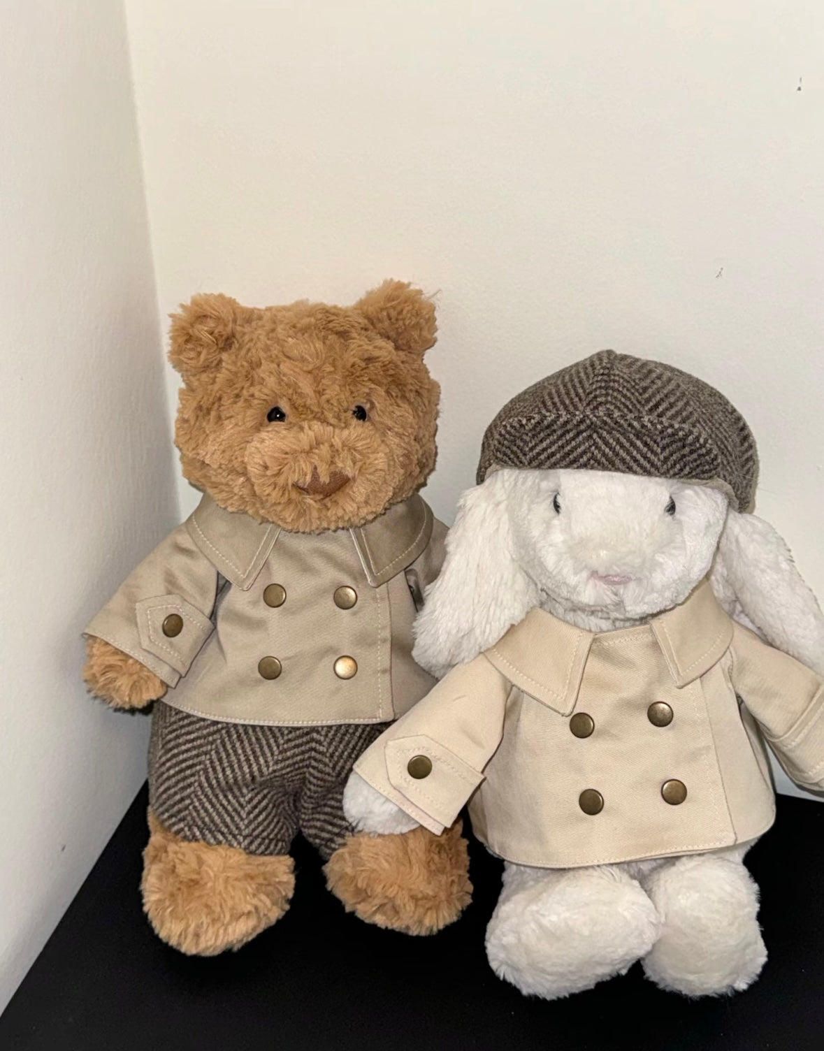 Bartholomew Bear and Bashful Bunny side by side wearing matching vintage detective outfits with trench coat and flat cap